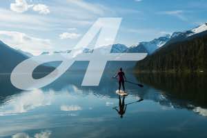 A stylized letter A floating over the image of a person on a stand-up paddleboard on a mountain lake