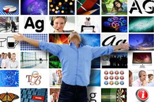 Elated man with outstretched arms standing in front of a wall of digital assets