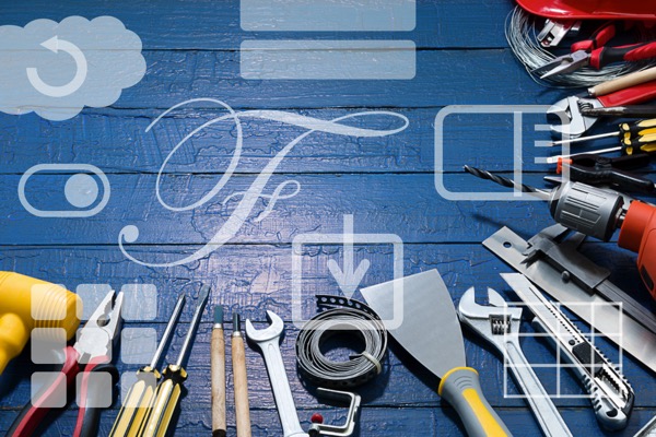 Image of hand tools against a wooden blue wall