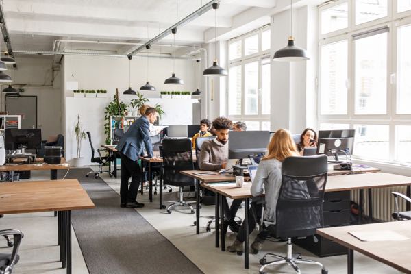 Image of a creative office loft with users working on computers